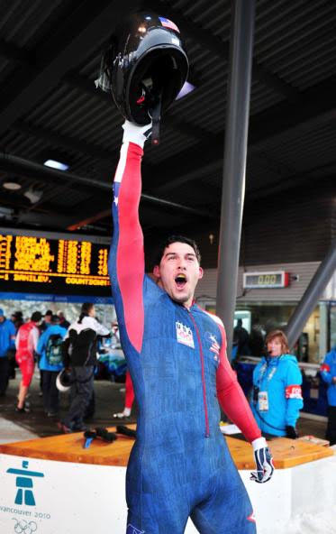 Athlete celebrating with helmet raised